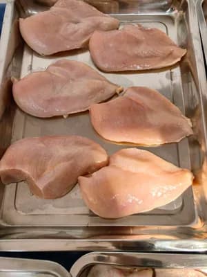 Frozen skinless boneless chicken breast, available in two grades